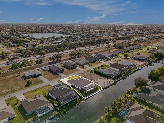 Aerial overview of property's location with nearby suburban area and a nearby body of water