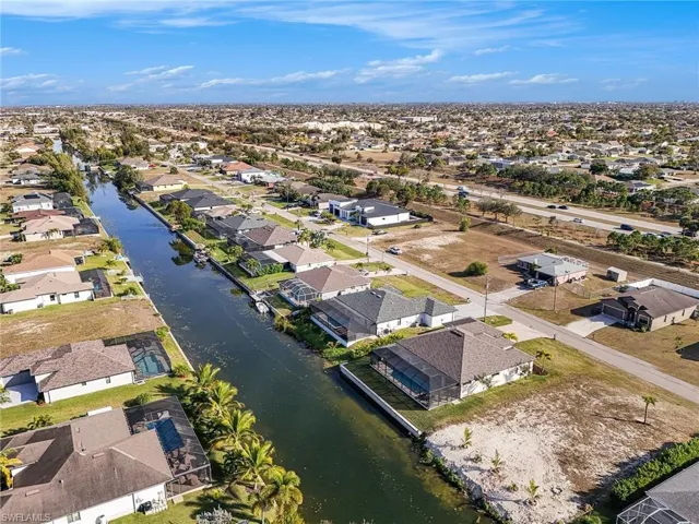 Aerial overview of property's location with nearby suburban area and a nearby body of water
