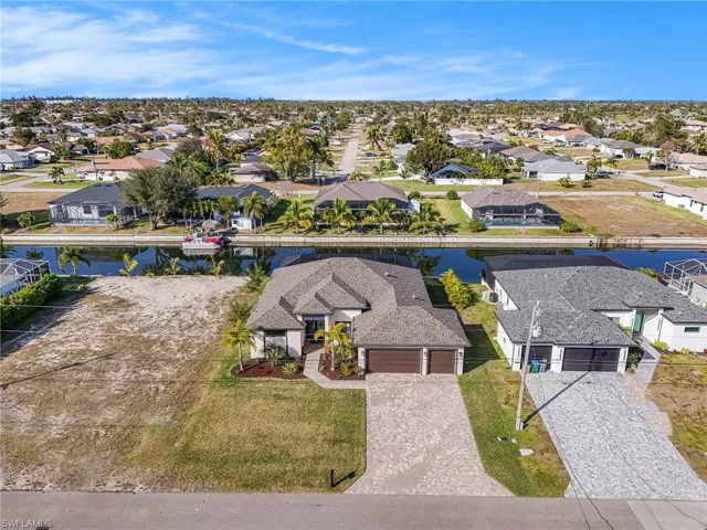 Aerial perspective of suburban area featuring a nearby body of water