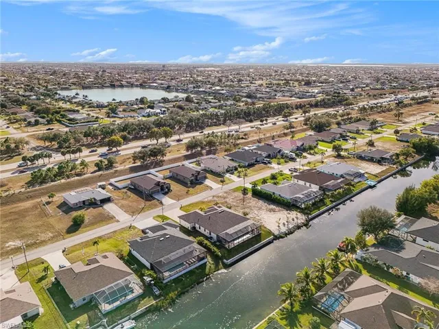 View of property location with a large body of water and nearby suburban area