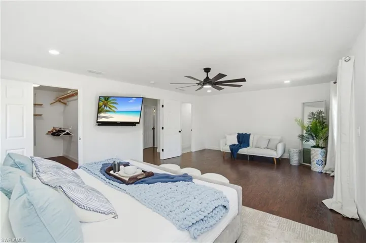 Spacious primary en-suite has an abundance of natural light and room for a separate seating area near the entry and balcony French doors.