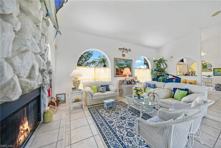 Living room featuring light tile patterned flooring and a fireplace