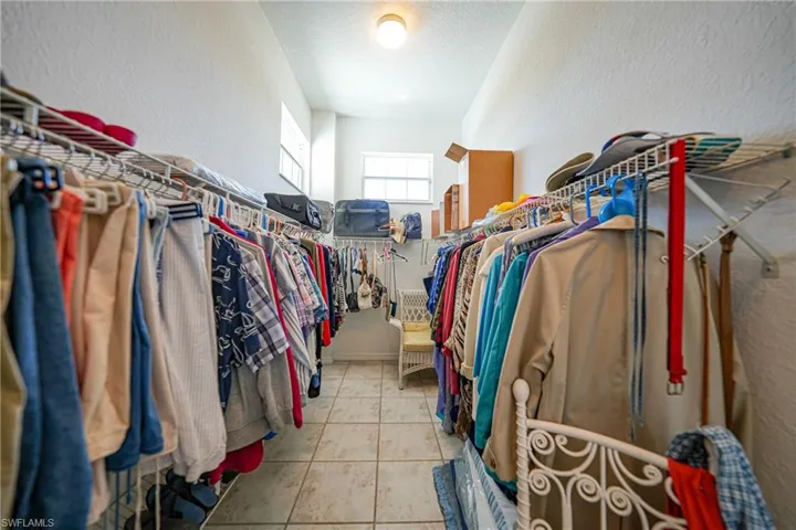 Walk in closet featuring light tile patterned flooring