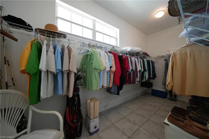 Spacious closet featuring lofted ceiling and light tile patterned floors