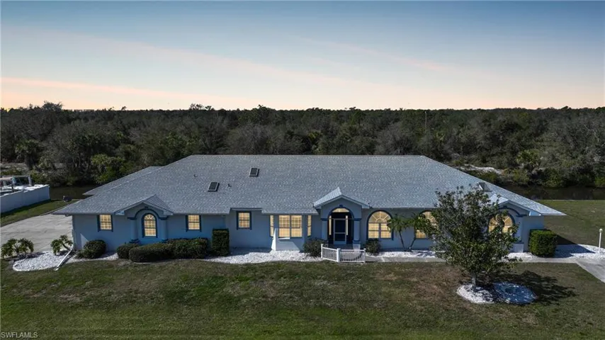 Ranch-style house featuring a lawn