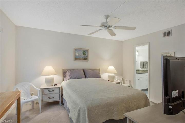 master bedroom with an en suite bathroom and walk in closet