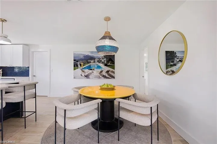 Dining area featuring light wood-style floors and baseboards