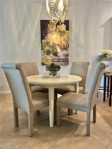 Dining space with hanging lights and baseboards
