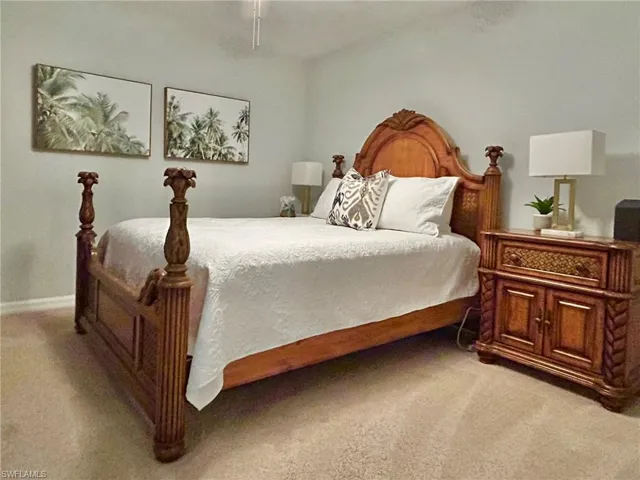 Bedroom featuring light carpet