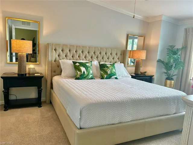 Bedroom featuring carpet floors and crown molding