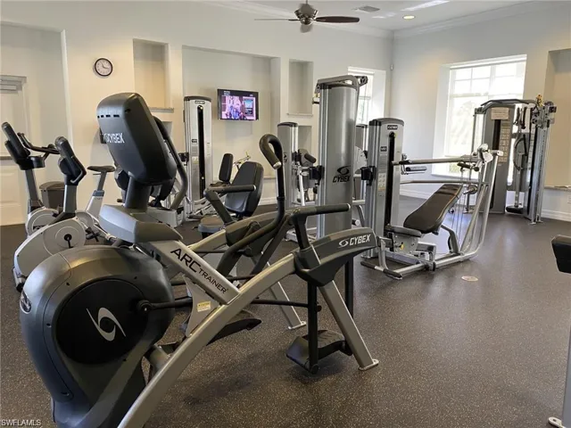 Exercise room with ceiling fan and crown molding