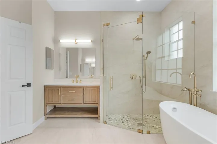 Custom Vanity with Oversized Shower and Floor to Ceiling Tile on the Wall