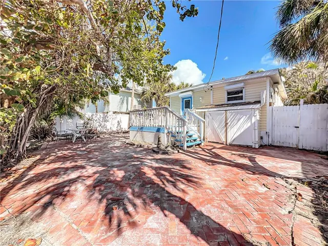 Rear view of house featuring a deck and a patio