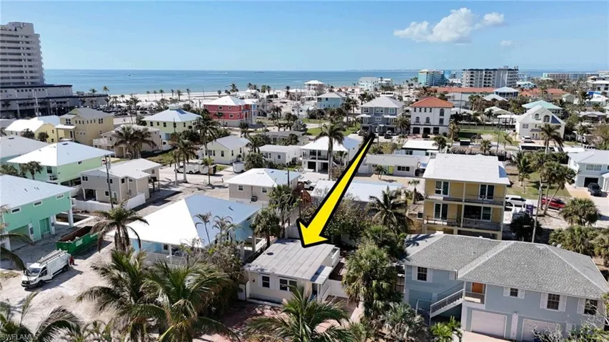 Birds eye view of property with a water view