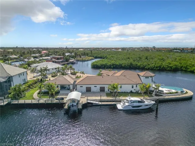 Privacy beyond on this over sized corner lot with 100' floating dock and covered boat lift.