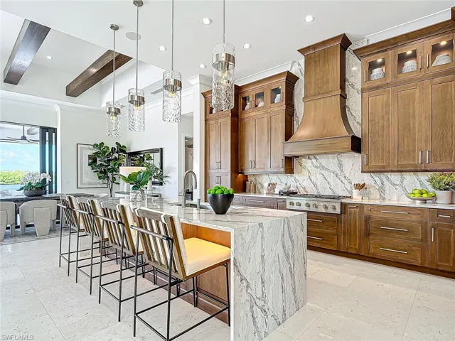 Under lit counter bar.  Stunning cabinets that bring out the beautiful quartz counter and backsplash.