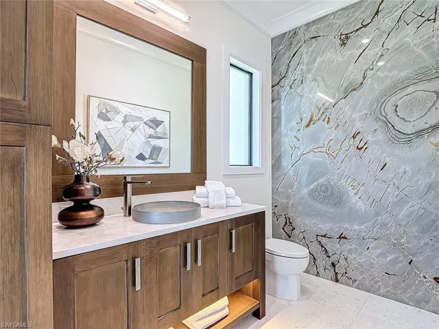 Half bath accessible from the pool area and also the den.