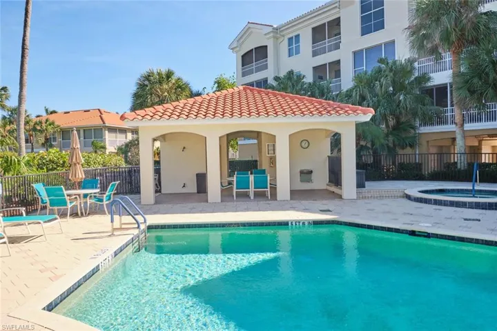View of swimming pool with a community hot tub and a patio area