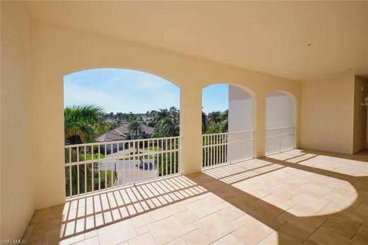 View of patio with a balcony