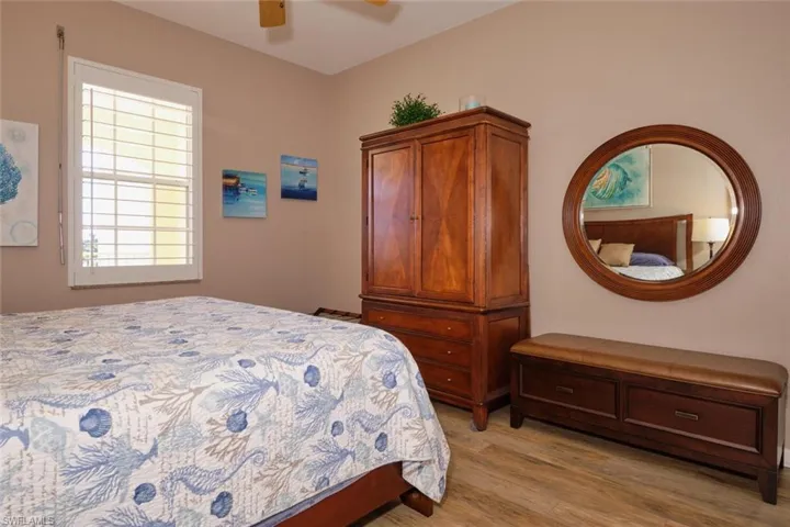 Bedroom with ceiling fan and light hardwood / wood-style floors