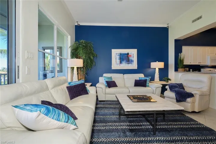 Living room featuring tile patterned floors and ornamental molding