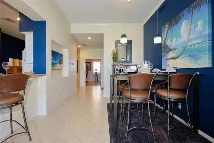 Dining room featuring light tile floors and crown molding