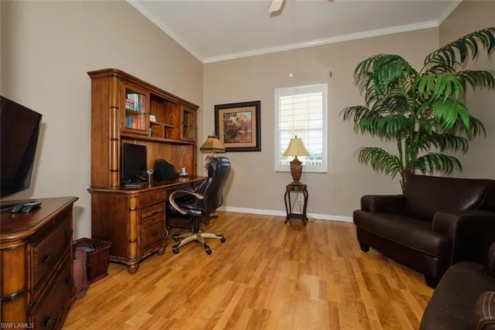 Office featuring crown molding, ceiling fan, and wood-style floors