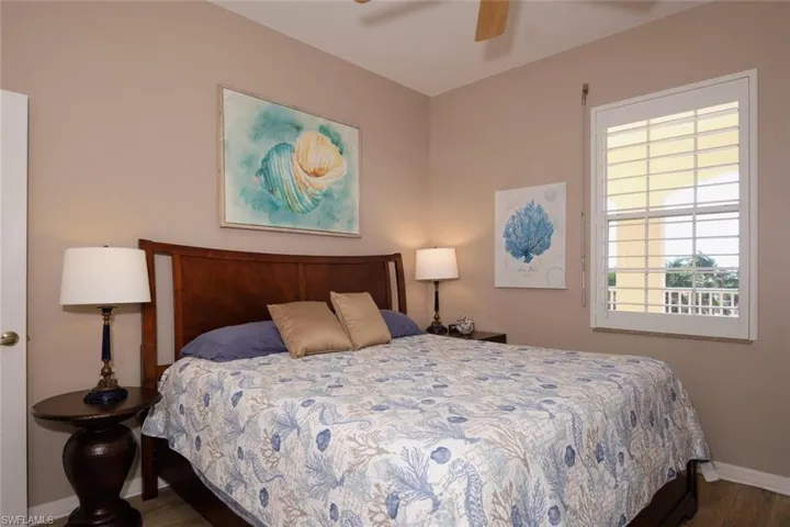 Bedroom featuring ceiling fan and dark wood-style flooring
