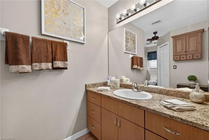 Bathroom with vanity and a ceiling fan