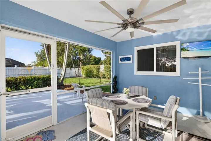 Sunroom / solarium with ceiling fan and outdoor dining space
