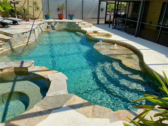 Resort style pool and spa boasting a 43' x 39' screened enclosure!