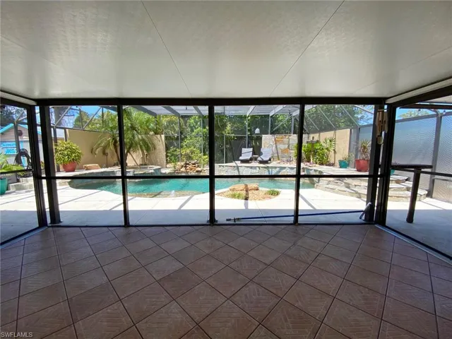 Screened room with screened sliding doors on either end that can be locked to keep your kids from accessing the pool if desired.