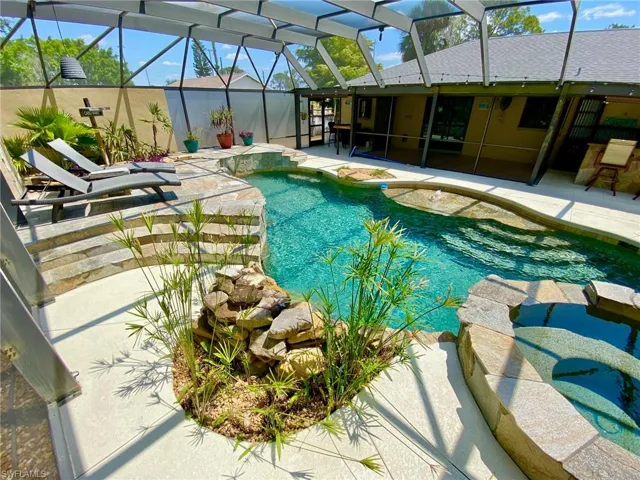 Resort style pool and spa boasting a 43' x 39' screened enclosure!  Privacy glass on the North screen.