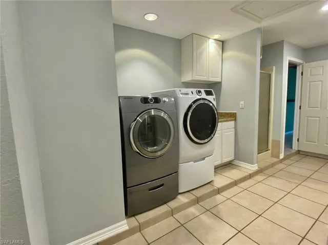 Laundry/mud room with a 3rd shower, washer, dryer and utility sink.