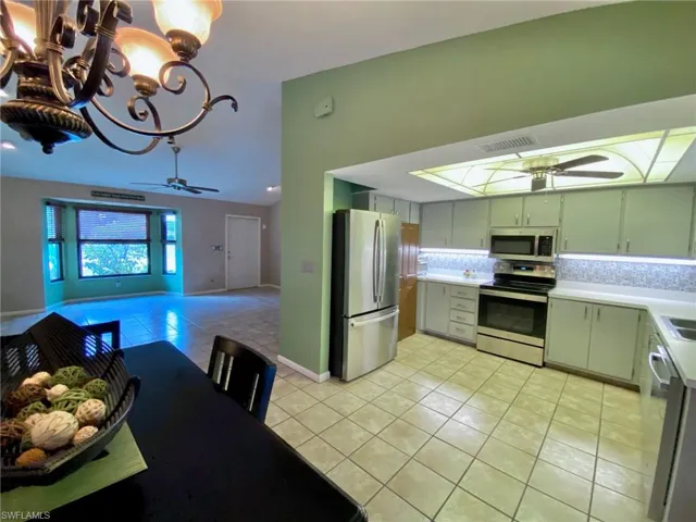 Great room with bay windows and the front door.