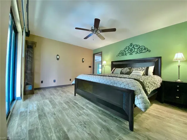 Spacious master bedroom with sliders to the wet bar and pool!