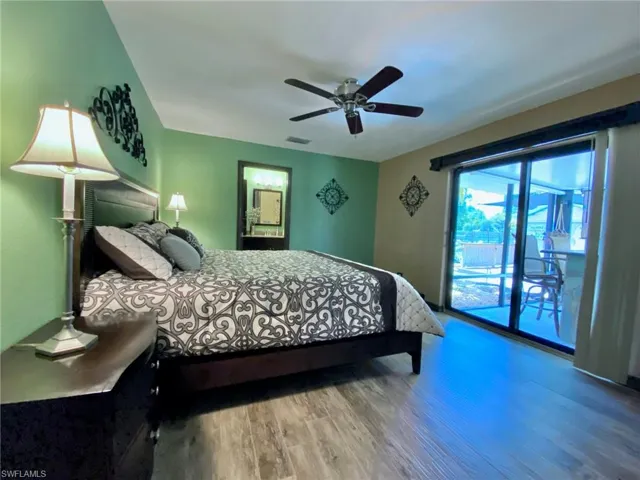 Spacious master bedroom with sliders to the wet bar and pool!
