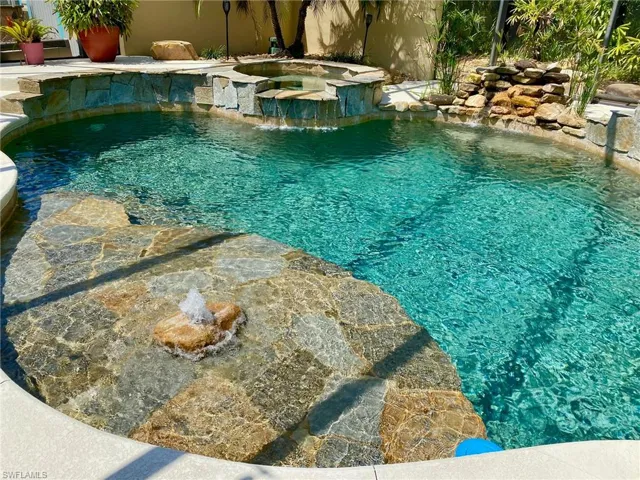 Large tanning ledge featuring a bubbler that comes up through a real boulder!