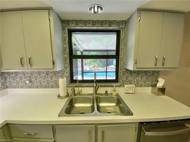 Kitchen cabinets are a neutral gray.