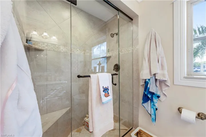 Full bath featuring a shower stall