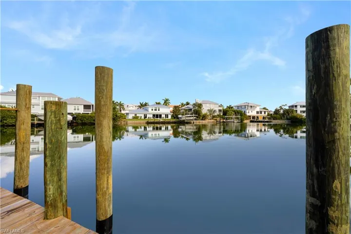 Water view with nearby suburban area and a dock