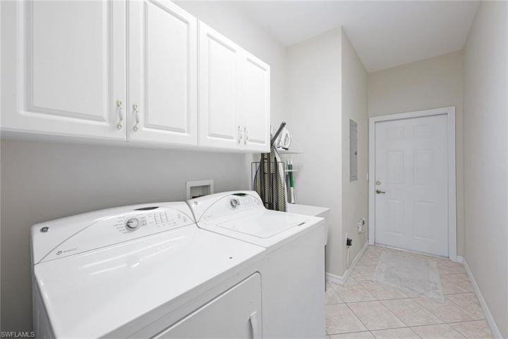 Spacious laundry room with plenty of storage.