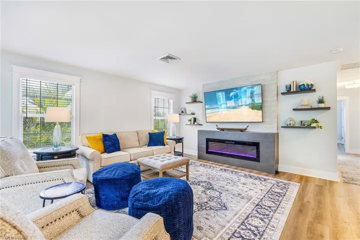 Living area featuring wood-finish flooring and multiple windows