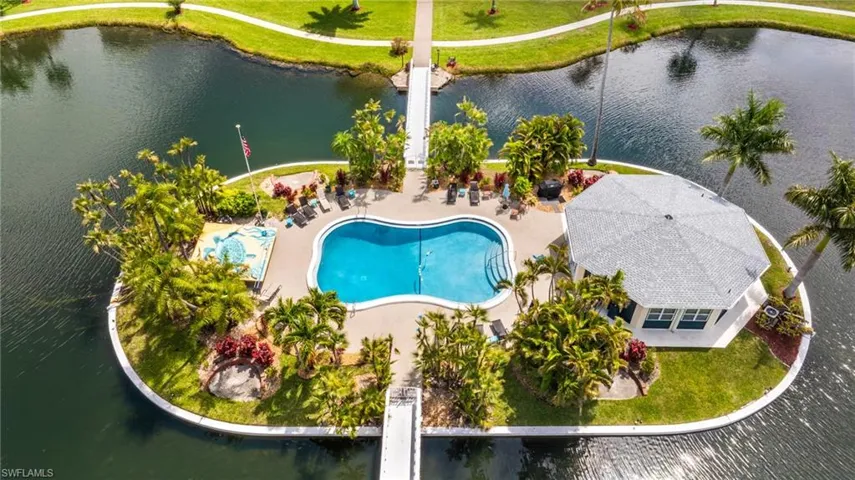 Island amenity center featuring a freeform swimming pool, spa, and a hexagonal pavilion building