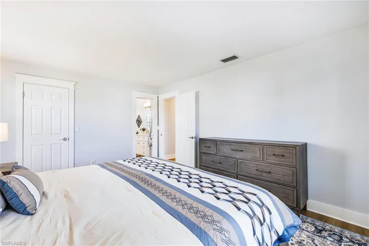 Neutral wall tones complement the wood-finish flooring