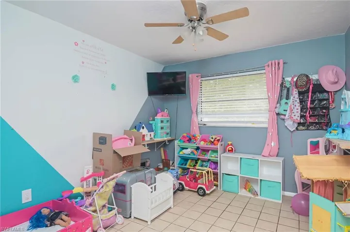 Playroom featuring ceiling fan and light tile patterned floors