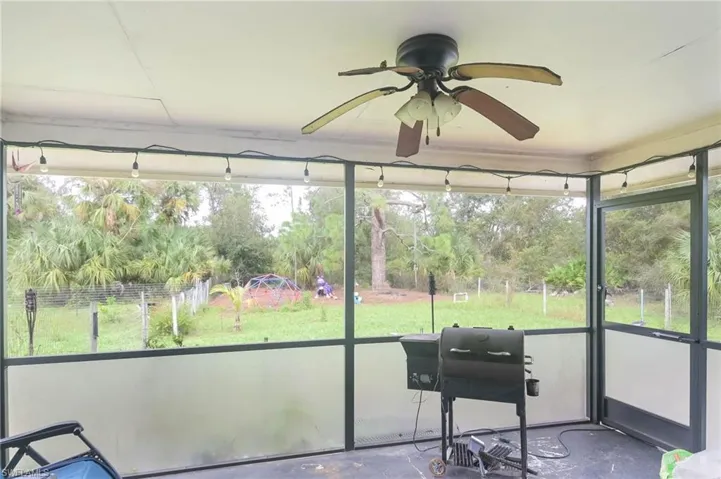 Sunroom / solarium featuring ceiling fan