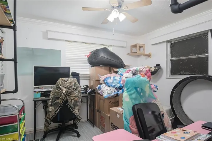 Office space with crown molding and ceiling fan