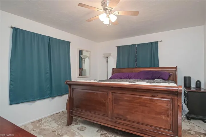 Bedroom with a textured ceiling and ceiling fan