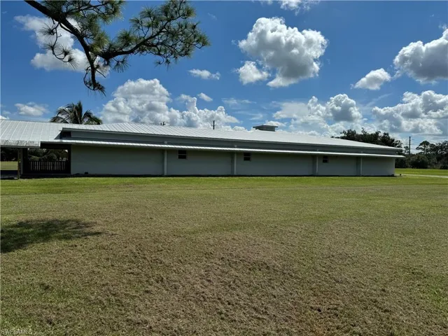 Rear view of property featuring a yard